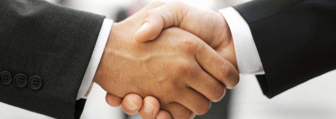 Photo of two men, shaking hands