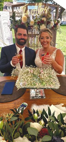 Happy couple toasting at wedding reception.