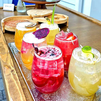 Refreshing summer cocktails displayed on a wooden tray