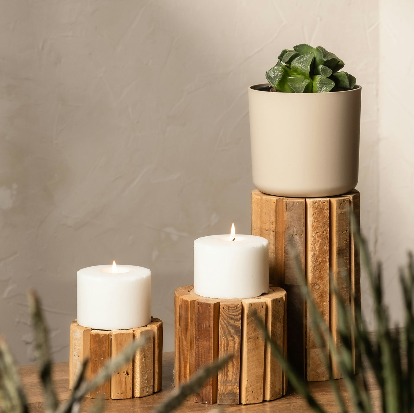 A couple of white candles sitting on top of a wooden table_edited.jpg