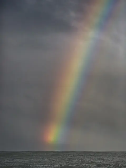 Photo by Tom Hoppa of a rainbow over the Pacific Ocean - California
