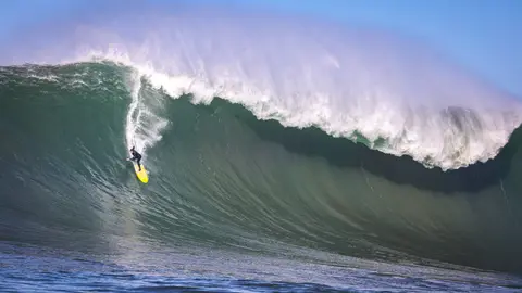 Photo of Colin Dwyer in the pipeline of a wave at Mavericks Surf Competition in Half Moon Bay, California. Photo Credit: Tom Hoppa.