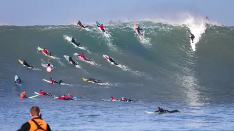 Photo of Ryan Augenstein & Friends in the pipeline of a wave at Mavericks Surf Competition in Half Moon Bay, California. Photo Credit: Tom Hoppa.