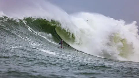 Photo of Luca Padua in the pipeline of a wave at Mavericks Surf Competition in Half Moon Bay, California. Photo Credit: Tom Hoppa.