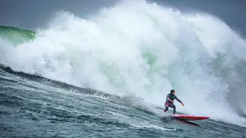 Photo of Bianca Valenti in the pipeline of a wave at Mavericks Surf Competition in Half Moon Bay, California. Photo Credit: Tom Hoppa.