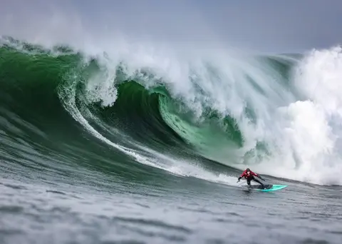 Photo of Peter Mel in the pipeline of a wave at Mavericks Surf Competition in Half Moon Bay, California. Photo Credit: Tom Hoppa.