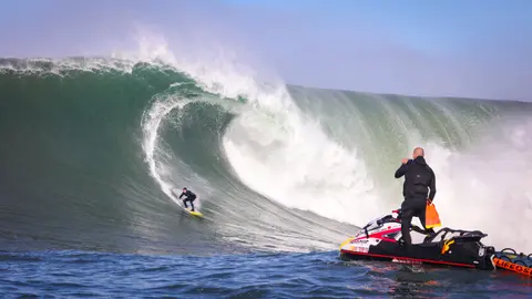 Photo of Colin Dwyer in the pipeline of a wave at Mavericks Surf Competition in Half Moon Bay, California. Photo Credit: Tom Hoppa.