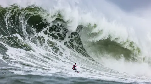 Photo of Luca Padua in the pipeline of a wave at Mavericks Surf Competition in Half Moon Bay, California. Photo Credit: Tom Hoppa.