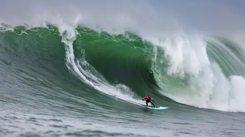 Photo of Peter Mel in the pipeline of a wave at Mavericks Surf Competition in Half Moon Bay, California. Photo Credit: Tom Hoppa.