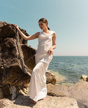 Experience the pure elegance of silk with Wedding Dress Elliana, a breathtakingly light and effortlessly graceful gown. Designed for the modern bride who values simplicity and sophistication, this 100% silk masterpiece embodies natural beauty and timeless style. The delicate drape and fluid movement of the fabric create an ethereal look, perfect for beach weddings, intimate ceremonies, and minimalist bridal aesthetics.

Key Features:
✔ Pure Silk Fabric – Luxuriously soft and lightweight for an effortless, graceful flow.
✔ Draped Open Back – A sensual, yet refined detail that adds a touch of sophistication.
✔ Minimalist Silhouette – A sleek and modern design that enhances natural beauty.
✔ Flowing Skirt – Provides a dreamy movement with every step.
✔ Perfect for Destination & Outdoor Weddings – Breathable and airy for all-day comfort.

Let the beauty of simplicity shine on your wedding day with Wedding Dress Elliana, where elegance meets effortless charm.

Custom-made to your measurements for the perfect fit.

Book your appointment today to experience the beauty of pure silk bridal fashion!

