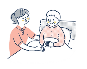 寝たきりの女性を介護するスタッフ