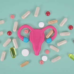 Pink uterus symbol surrounded by assorted pills on a teal background, suggesting a focus on reproductive health and medicine.
