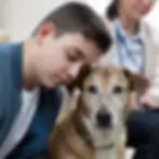 Boy resting head on a brown dog's head, both looking calm. Woman in a white jacket blurred in the background. Indoor setting, soft lighting.