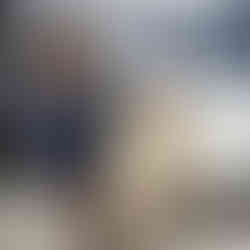 SKT staff member finishing tying a new bandage around his head.