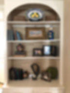 styled shelves with grasscloth
