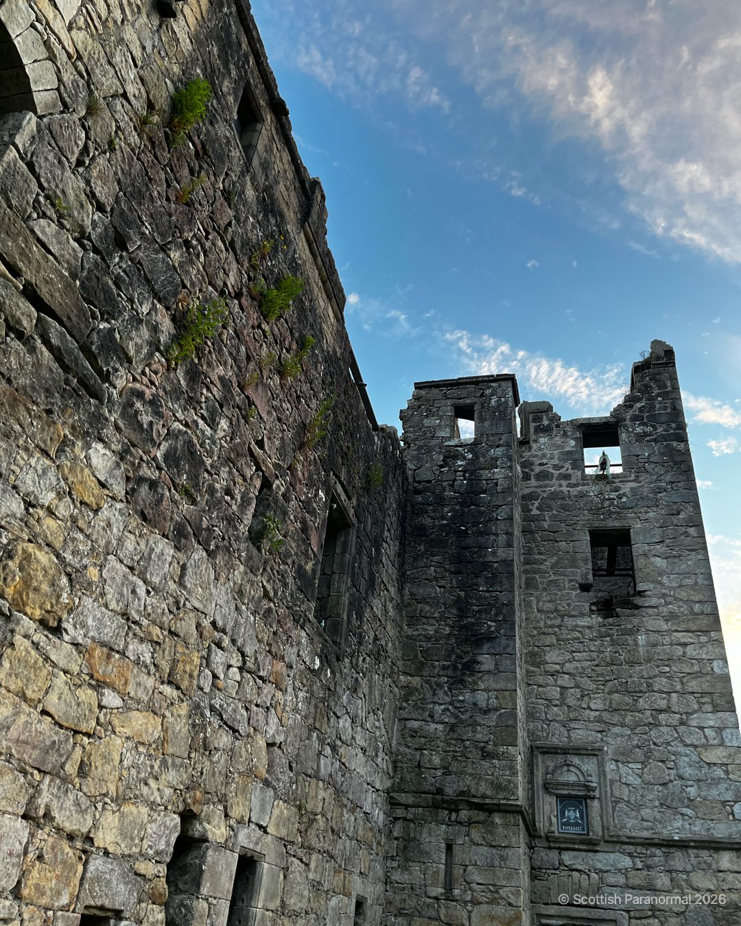 Looking up from Torwood Castle’s courtyard towards the tower entrance and open upper walls.