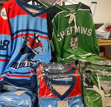 Hanging blue player jersey, green 'CHIEFTAINS' jersey, folded