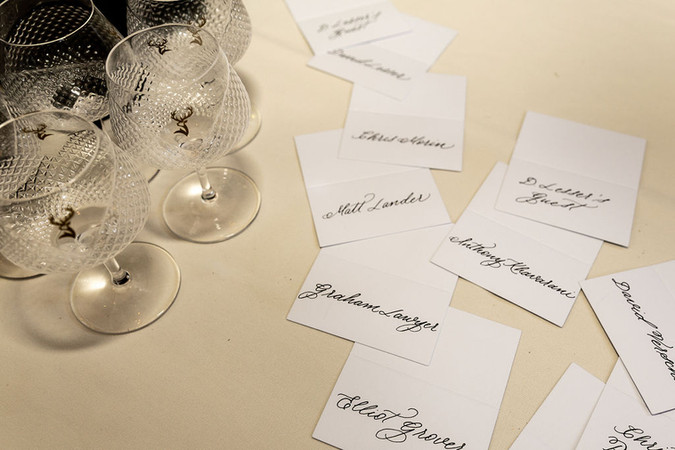 hand calligraphed name cards with black ink on white paper