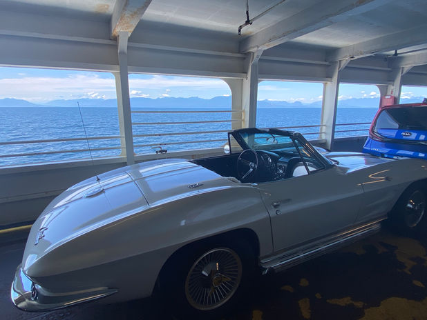 White convertible on ferry with ocean view