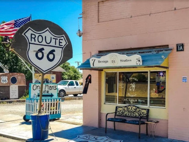Route 66 sign next to a pink building