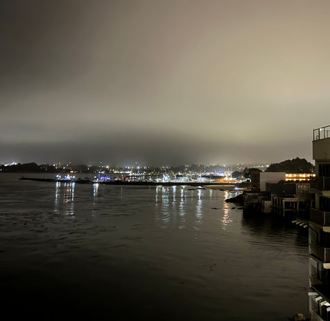 City lights reflecting on water at night