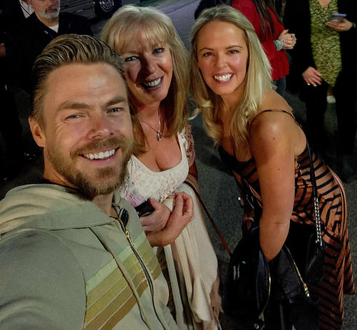 Three smiling people at an event