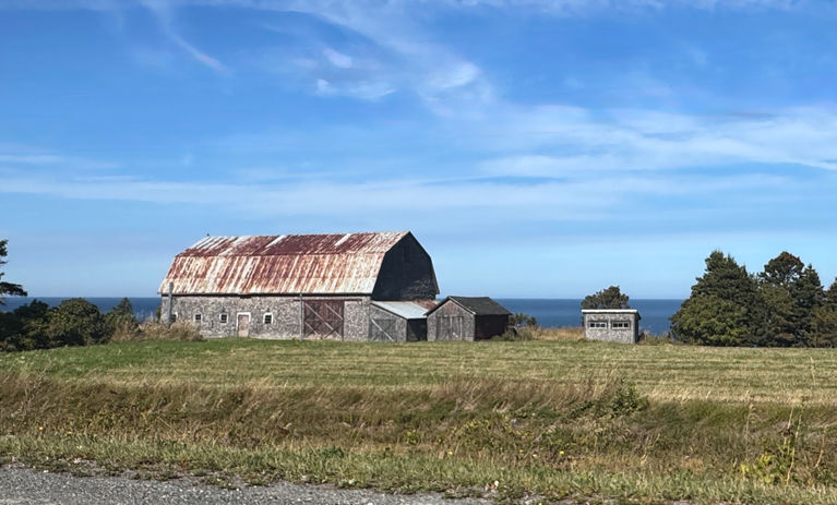 Old barn with rusty roof by the ocean