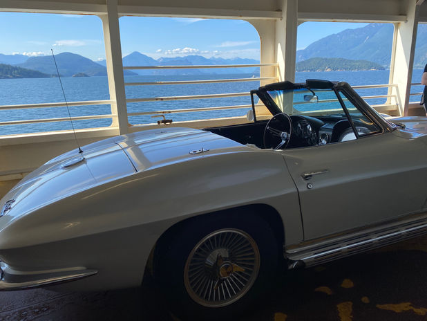 Classic white convertible car on a ferry