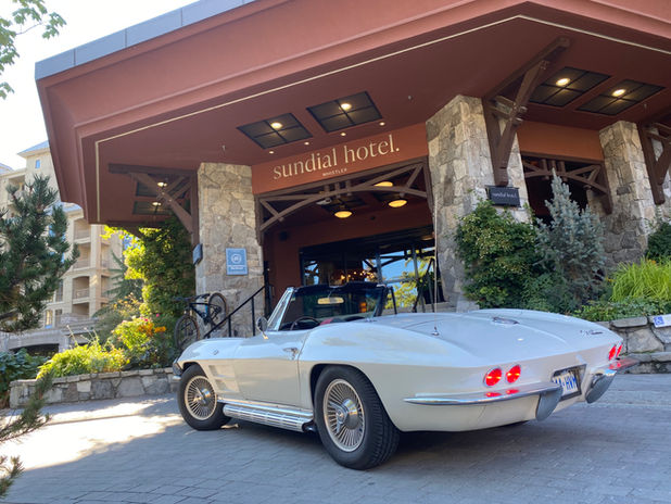 White convertible car parked in front of Sundial Hotel