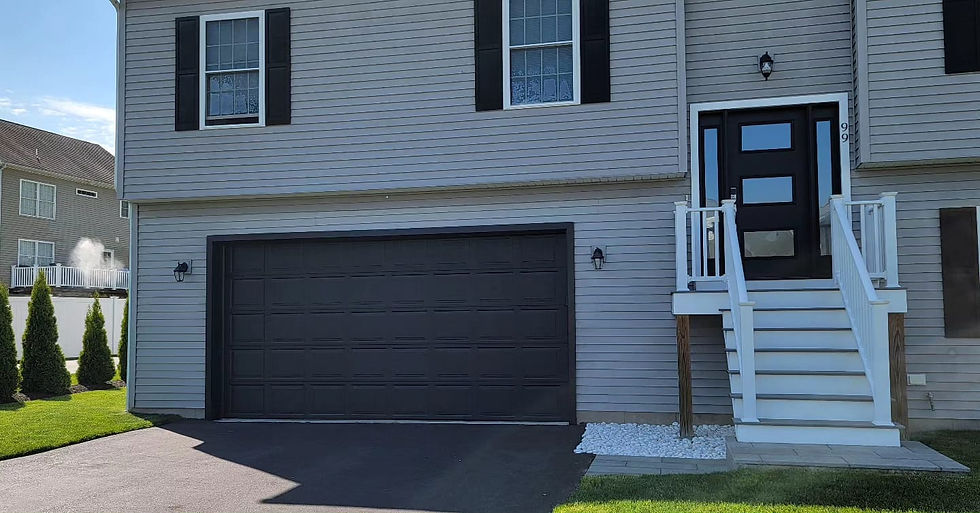 Two-story gray house with garage and modern front door