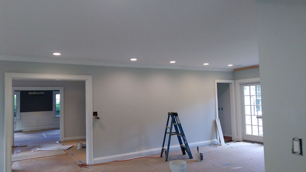 Renovated room with light grey walls and recessed lighting