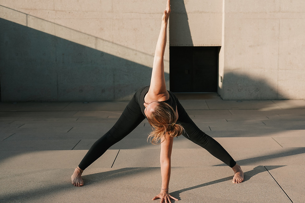 Frau in einer Yogahaltung stehende Vorwärtsbeuge und dreht den Oberkörper nach rechts zur Sonne auf