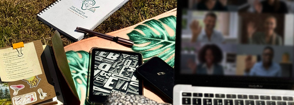 laptop screen on zoom surrounded by journaling supplies