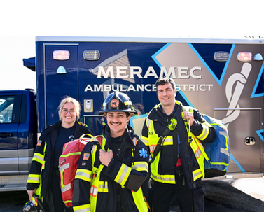 Meramec Ambulance District team standing together in front of an ambulance, celebrating the successful passing of Proposition A in April 2025.