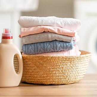 folded laundry with washer in background