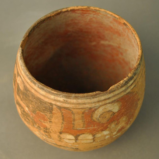 Cup, vessel made of pottery. Oviform, in warm buffware, ornamented externally in white, red and brown, with skull and cross design. © The Trustees of the British Museum