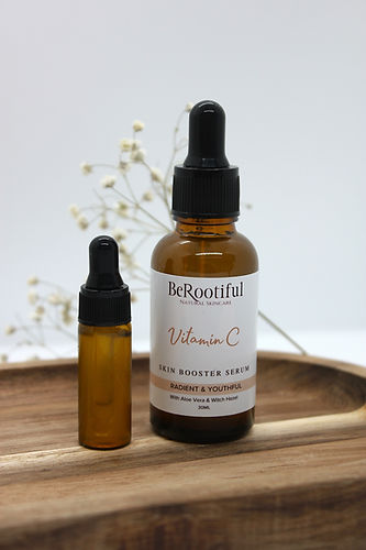 Two brown bottles with Vitamin C serum on wooden tray BeRootiful.