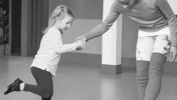 Young tap dancing student  with tap teacher learning how to perform a shuffle
