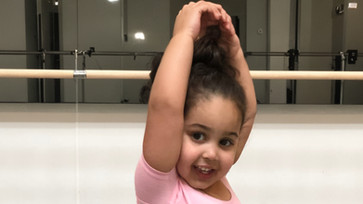 Baby ballet dancer with arms in fifth