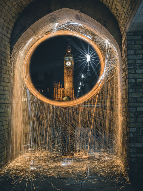 Big Ben at night. The clock tower is framed by spinning light 