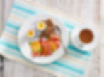 Soft boiled eggs with toast, fruit and tea