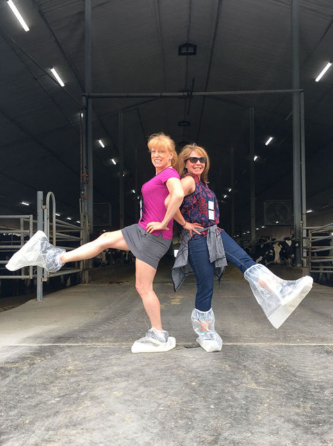 Carol and Shannon wearing plastic booties at a farm