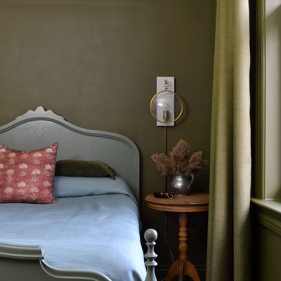 tone on tone olive green bedroom with natural wood accents