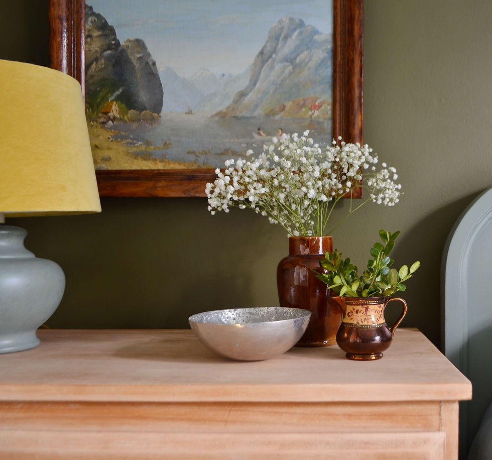 vintage vignette with oil painting, lamp, little brown jug, ironware