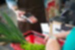 Woman paying for groceries with a handheld card reader