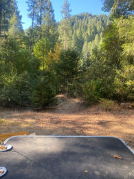 toy hauler open facing the forrest and trees at a camp site in Downieville ca