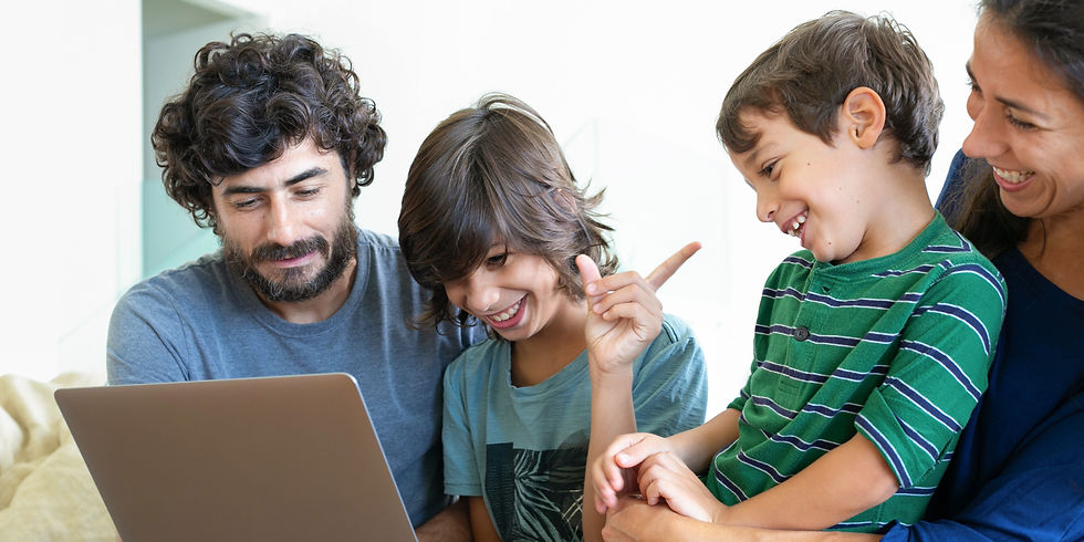 A family explores educational opportunities together, with parents engaging their children in planning for the future using a laptop.