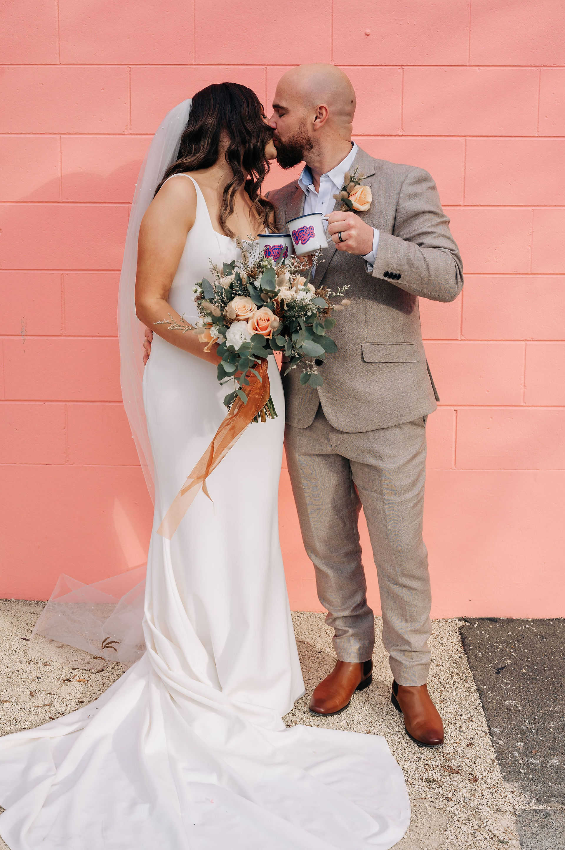 Lucy and Hamish Wedding - Bride and Groom, Bareno cocktails in front of Pink Wall 