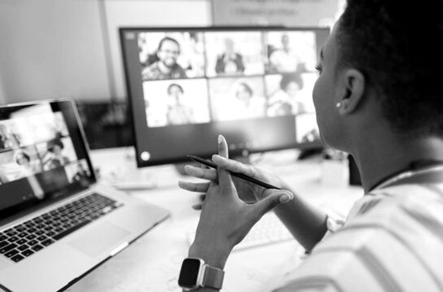 Woman on video conference on laptop and desktop