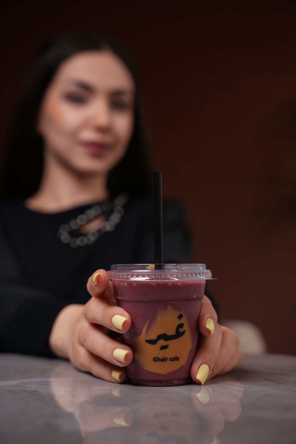 Iced berry smoothie in Ghair Cafe branded cup